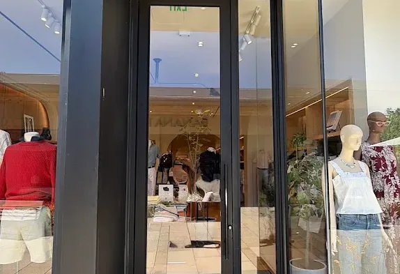Framed glass double doors at a commercial building entrance.