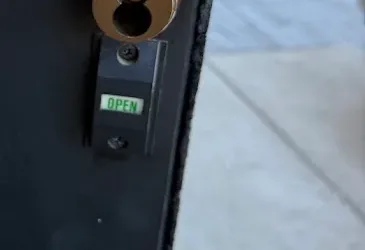 Close-up of a commercial door cylinder and keys.
