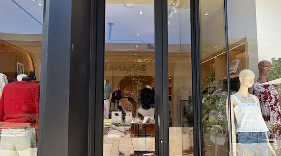 Framed glass double doors at a commercial building entrance.