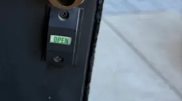 Close-up of a commercial door cylinder and keys.