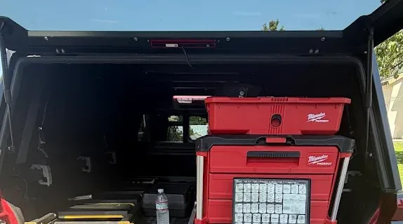 Locksmith key and pinning equipment arranged inside an open service truck.