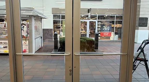 Storefront glass doors viewed from inside the building.
