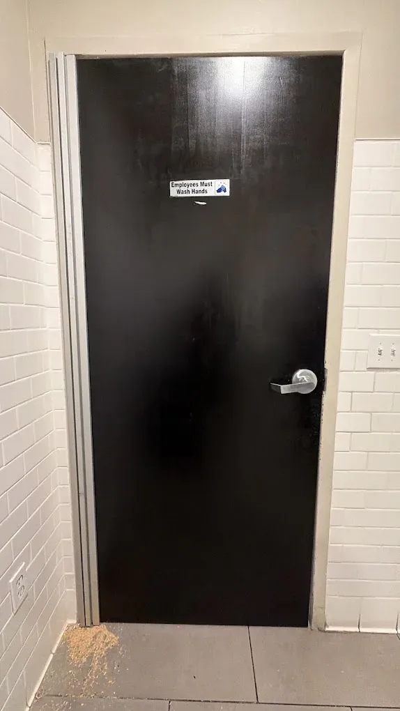 Black interior door with lever hardware.