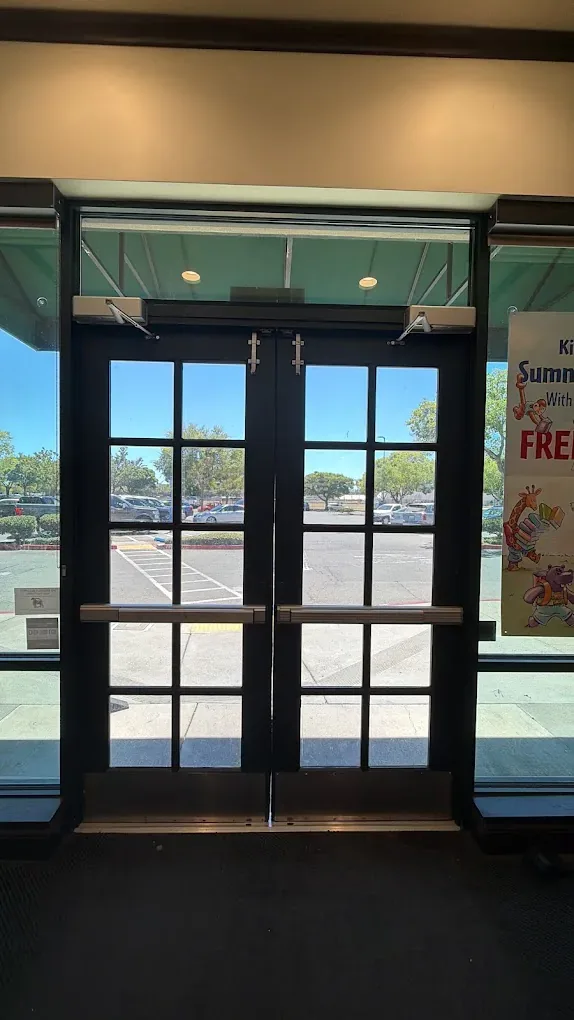 Dark metal-framed glass entrance doors in a commercial building.