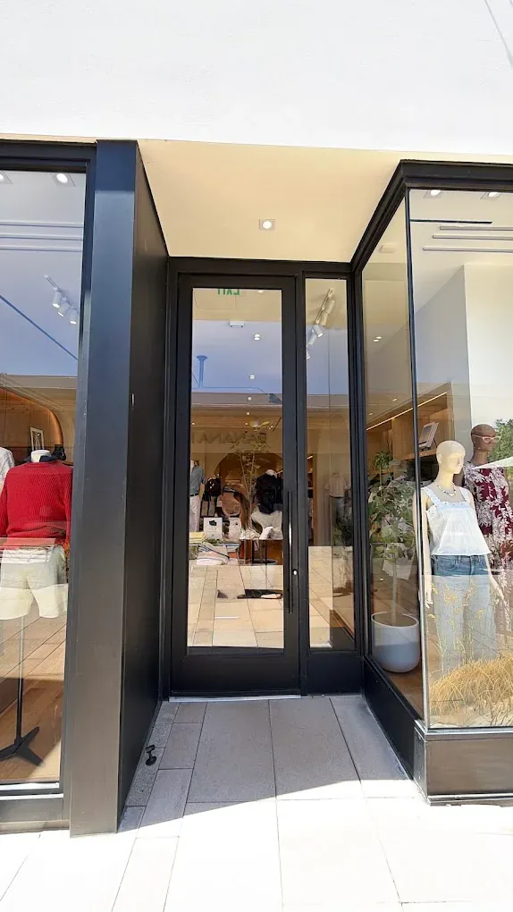 Framed glass double doors at a commercial building entrance.