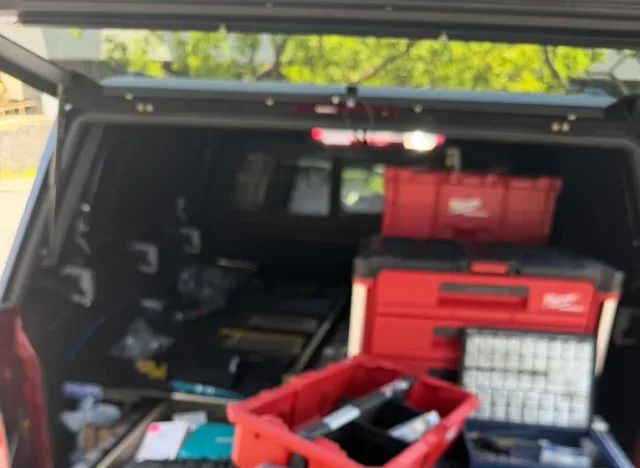 Locksmith tool cases and key pins arranged in an open service truck.