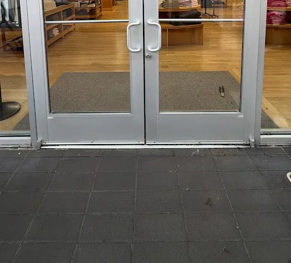 Exterior glass entry doors and metal handles.